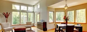Replacement vinyl windows in an open-plan living and dining area.